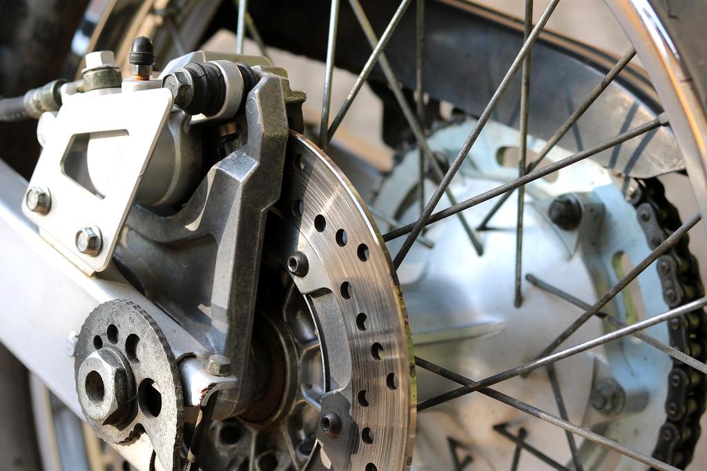 Professional bike mechanic working on road bike in modern repair shop